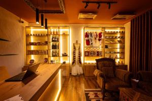 a bar with a laptop on a table in a room at Gegë Boutique Hotel in Gjakove +48 photos
