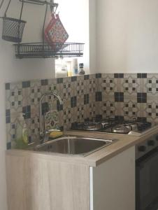 a kitchen with a sink and a stove at Casa Annina in Basilicata in Trivigno
