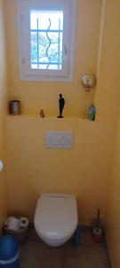 a bathroom with a toilet and a window at Le mas christiane in Buis-les-Baronnies