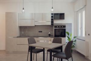 a kitchen with a table and chairs in a room at Villa IV - PRIVATE LIVING in Alghero