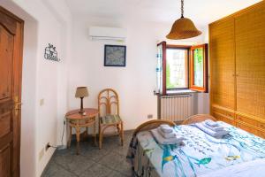 a bedroom with a bed and a table and chairs at Residence Parco Gioconda in Forio d'Ischia
