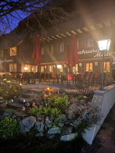 a restaurant at night with a garden in front at Hotel-Restaurant Maien in Todtmoos