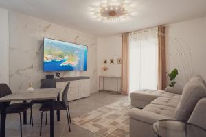a living room with a couch and a table at Villa IV - PRIVATE LIVING in Alghero