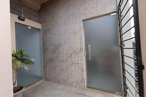 a pivot door in a room with a brick wall at Mini Privativa CA1 - Tiradentes / MG in Belo Horizonte