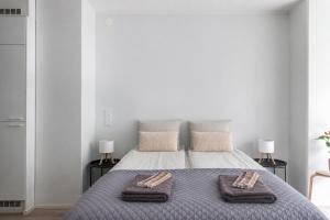 a bedroom with a bed with two towels on it at Modern Studio in Downtown Lahti in Lahti