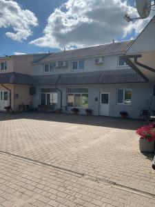 a large house with a brick driveway in front of it at Ночівля in Poltava