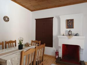 a dining room with a table and a fireplace at Heidis Haus in Polygryos