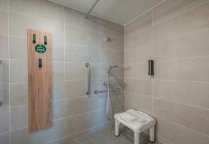 a bathroom with a shower with a toilet and a sink at B&B HOTEL Mâcon Sud 3 étoiles in Varennes-lès-Mâcon +32 photos