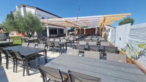 a row of tables and chairs in a patio at Villa Klara in Gedići