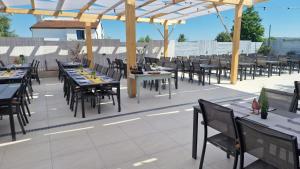 an outdoor dining area with tables and chairs at Villa Klara in Gedići +4 photos