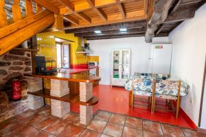 a kitchen with a table and a couch in a room at El Llagar de Ternín in Villaviciosa
