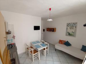 a small room with a table and a couch at GRomano Apartments in Ischia Town