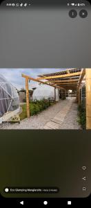 a picture of a building with a wooden roof at Eco Glamping Manglaralto in Santa Elena