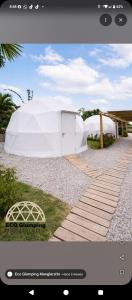 a white tent sitting on top of a walkway at Eco Glamping Manglaralto in Santa Elena