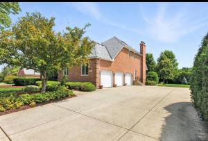 a brick house with a driveway at AEQ Luxury House 1 in Orland Park