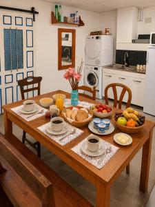 a wooden table with bowls of food on it in a kitchen at Albergue Vía Vitae in Otur