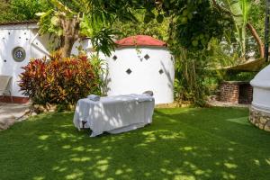 a table on the grass in a garden at Casa ANTAHKARANA in Puerto Vallarta