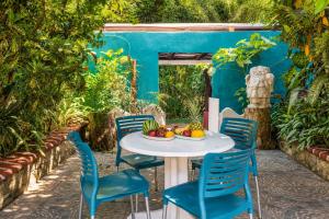 a white table and chairs with fruit on it at Casa ANTAHKARANA in Puerto Vallarta +46 photos