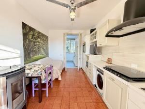 a kitchen with a table and a dining room at Vear Hausing - Volano 80 int 8 in Lido di Volano