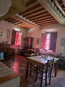 a dining room with tables and chairs and windows at Due Borghi Guest House in Pisa