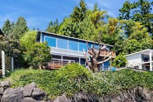 a house on the beach with a tree at Rockaway Beach View in Port Blakely