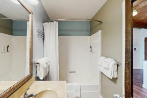 a bathroom with a sink and a shower and a mirror at Rockaway Beach View in Port Blakely +11 photos
