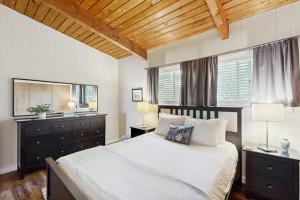 a bedroom with a large bed and a large mirror at Rockaway Beach View in Port Blakely