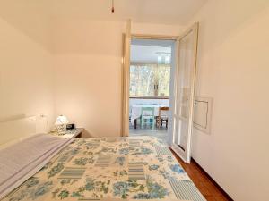 a bedroom with a bed and an open door at Vear Hausing - Volano 80 int 8 in Lido di Volano