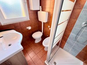 a bathroom with a toilet and a sink and a shower at Vear Hausing - Volano 80 int 8 in Lido di Volano +16 photos