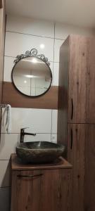 a bathroom with a stone sink and a mirror at Gorsko zavetje Cottage in Soča