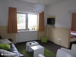 a living room with a couch and a table at Villa Boskoop in Stryck