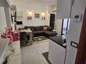 a kitchen and living room with a couch and a table at La dimora di Gabi in Marghera +7 photos