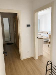 a living room with a room with a couch and a mirror at Our story Apartment in Milovići
