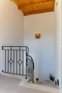 a staircase in a white room with a ceiling at Orange House - Upper West apartment in Promírion