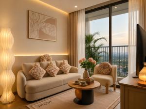 a living room with a couch and a balcony at Vinhomes D'capitale Hanoi Opus in Hanoi
