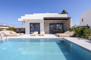 a villa with a swimming pool and a house at Noera Villas in Kremasti