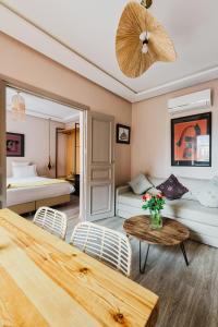a hotel room with two beds and a table with chairs at Amani Hotel Suites & Spa in Marrakesh +56 photos