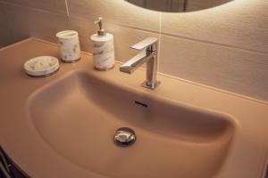 a bathroom sink with a faucet and candles on it at Villa IV - PRIVATE LIVING in Alghero +26 photos