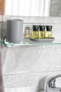 a glass shelf with three candles on a plate at Bronte Breaks in Haworth +32 photos