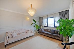 a living room with two couches and a chandelier at Zumra's White Houses in Trabzon