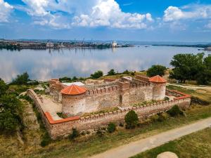 an old castle on the shore of a lake at Apartman Točaković in Kladovo