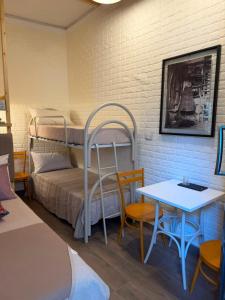 a room with a bunk bed and a table and chairs at Attardo's House in Catania