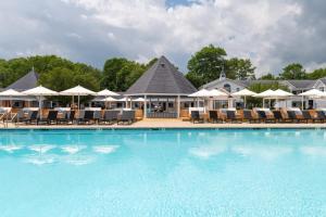 a pool at a resort with chairs and umbrellas at Driftaway Hotel and Pool in Ogunquit