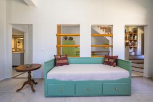 a bed in a room with a table and shelves at Old Town Tower House in Kos