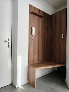 a wooden wall with a bench in a room at Studio11 in Medzilaborce