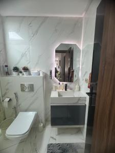 a white bathroom with a sink and a toilet at Mehdia plage in Kenitra +24 photos
