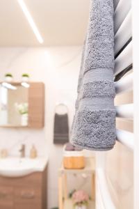 a bathroom with a towel hanging on the wall at La Casa Seni Near Athens Airport in Papangeláki +58 photos