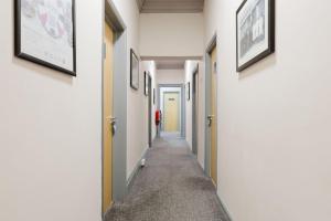 a hallway with white walls and a long aisle at Southern Cross in Watford