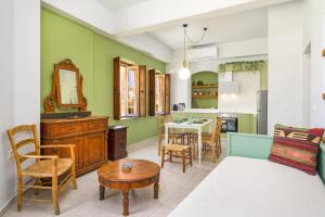 a kitchen and living room with a table and chairs at Old Town Tower House in Kos