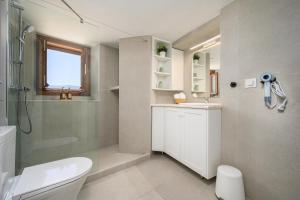 a bathroom with a shower and a toilet and a sink at Old Town Tower House in Kos +33 photos